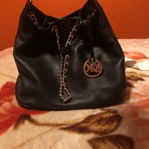 A black leather hang bag